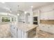 Open concept kitchen with large island, stainless appliances, and breakfast nook at 22737 N Sunset Dr, Maricopa, AZ 85139