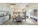 Eat in kitchen with island, modern appliances, breakfast table and view to backyard at 22737 N Sunset Dr, Maricopa, AZ 85139