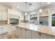 White kitchen featuring a granite island, stainless steel appliances, and ample cabinet space at 22737 N Sunset Dr, Maricopa, AZ 85139