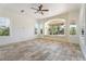 Bright living room featuring a bay window with cushioned seating and a ceiling fan at 22737 N Sunset Dr, Maricopa, AZ 85139