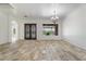 Spacious living room with decorative chandelier and arched doorway at 22737 N Sunset Dr, Maricopa, AZ 85139
