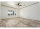 Bright living room with large windows and modern tile flooring at 22737 N Sunset Dr, Maricopa, AZ 85139