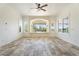 Bright living room featuring a bay window with cushioned seating and a ceiling fan at 22737 N Sunset Dr, Maricopa, AZ 85139
