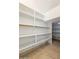 Spacious walk-in pantry featuring ample shelving for organized storage at 22737 N Sunset Dr, Maricopa, AZ 85139