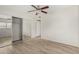 This bright bedroom features a ceiling fan, closet, and wood-look floors at 234 N 75Th St # 209, Mesa, AZ 85207