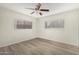 This bright bedroom features a ceiling fan and wood-look floors at 234 N 75Th St # 209, Mesa, AZ 85207
