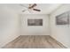 This bright bedroom features a ceiling fan and wood-look floors at 234 N 75Th St # 209, Mesa, AZ 85207