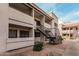 Exterior shot of a well maintained two-story condo building with exterior stairwell at 234 N 75Th St # 209, Mesa, AZ 85207