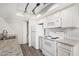 Bright kitchen features white appliances and granite countertops, plus a laundry closet at 234 N 75Th St # 209, Mesa, AZ 85207
