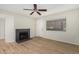Cozy living room boasting ceiling fan, window, fireplace, and wood-look flooring at 234 N 75Th St # 209, Mesa, AZ 85207