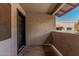 Patio area with neutral toned stucco and modern black door at 234 N 75Th St # 209, Mesa, AZ 85207