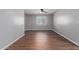 Bright bedroom with hardwood floors and a large window at 24813 W Rosita Ave, Buckeye, AZ 85326