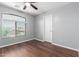 Bedroom with a view from the window with dark wood flooring at 24813 W Rosita Ave, Buckeye, AZ 85326