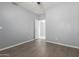 Bedroom with a ceiling fan, light gray walls, and attached bath at 24813 W Rosita Ave, Buckeye, AZ 85326