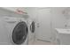 Convenient laundry area with modern washer, dryer, utility sink, and ample storage space at 24813 W Rosita Ave, Buckeye, AZ 85326