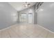 Bright living room with a vaulted ceiling, fan, and neutral color palette at 24813 W Rosita Ave, Buckeye, AZ 85326