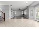 Bright and open living room featuring tiled floors, ceiling fan, and natural light at 24813 W Rosita Ave, Buckeye, AZ 85326