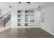 Inviting living room featuring built-in shelving, gray walls, and wood-look tile floors at 24813 W Rosita Ave, Buckeye, AZ 85326