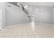Open floor plan with high ceilings, neutral tile flooring, and staircase at 24813 W Rosita Ave, Buckeye, AZ 85326