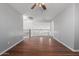 Open loft area with hardwood floors, neutral walls, and a ceiling fan at 24813 W Rosita Ave, Buckeye, AZ 85326