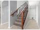 Staircase featuring carpeted stairs, iron spindles, and a wood handrail at 24813 W Rosita Ave, Buckeye, AZ 85326