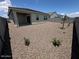 Private backyard featuring gravel, block fencing, and a covered patio for relaxing outdoor living at 25165 N 183Rd Dr, Wittmann, AZ 85361