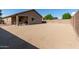Large backyard with low-maintenance desert landscaping, covered patio, and a block fence for privacy and security at 25447 W Heathermoor Dr, Buckeye, AZ 85326