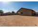 Spacious backyard featuring desert landscaping, a covered patio, and block fencing, offering a private and relaxing outdoor space at 25447 W Heathermoor Dr, Buckeye, AZ 85326