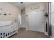 Bedroom with closet and bathroom access and dinosaur themed decor at 25447 W Heathermoor Dr, Buckeye, AZ 85326