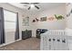 Bedroom featuring dinosaur themed decor and a white crib at 25447 W Heathermoor Dr, Buckeye, AZ 85326