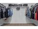 Walk-in closet featuring organized storage and carpeted flooring at 25447 W Heathermoor Dr, Buckeye, AZ 85326