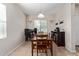 Inviting dining room with tile floors and natural light, featuring a dining table set and a window view at 25447 W Heathermoor Dr, Buckeye, AZ 85326