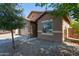 Exterior side view of the home, showcasing the driveway and low-maintenance landscaping at 25447 W Heathermoor Dr, Buckeye, AZ 85326