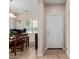 Inviting foyer with a white front door, neutral tones, and tiled flooring, with a view of the dining area at 25447 W Heathermoor Dr, Buckeye, AZ 85326