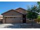 Charming single-story home with a well-maintained front yard and welcoming entryway at 25447 W Heathermoor Dr, Buckeye, AZ 85326
