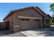 Exterior shot showing the two-car garage and driveway, situated on a well-maintained lot with desert landscaping at 25447 W Heathermoor Dr, Buckeye, AZ 85326