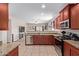 Well-lit kitchen featuring granite countertops, stainless steel appliances, and rich wood cabinetry at 25447 W Heathermoor Dr, Buckeye, AZ 85326