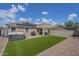 Inviting backyard featuring a hot tub, artificial turf, and a covered patio for outdoor relaxation and entertainment at 25930 N 165Th Ln, Surprise, AZ 85387
