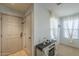 Bright entryway with white walls, beige tile flooring, and large window at 25930 N 165Th Ln, Surprise, AZ 85387