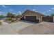 Two-car garage with a brick paver driveway and neutral-toned exterior at 25930 N 165Th Ln, Surprise, AZ 85387