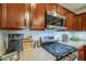This kitchen boasts stainless steel appliances, granite countertops, and beautiful wood cabinets at 25930 N 165Th Ln, Surprise, AZ 85387
