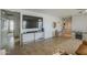 Open living space features tile flooring, large television, and lots of storage at 25930 N 165Th Ln, Surprise, AZ 85387