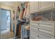 This organized walk-in closet with white cabinets and mirror provides ample storage at 25930 N 165Th Ln, Surprise, AZ 85387