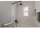 Bright remodeled bathroom with subway tile surround and black fixtures and rain shower head at 3202 W Glenrosa Ave, Phoenix, AZ 85017