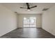 Bedroom with neutral walls, grey wood flooring, ceiling fan and sliding glass doors leading to the backyard at 3202 W Glenrosa Ave, Phoenix, AZ 85017