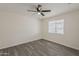 Bright bedroom with neutral walls, grey wood flooring, and a ceiling fan at 3202 W Glenrosa Ave, Phoenix, AZ 85017