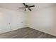 Bright bedroom featuring fresh white walls, a ceiling fan, and wood-look flooring and double door closet at 3202 W Glenrosa Ave, Phoenix, AZ 85017