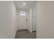 Clean hallway with gray floors and a door with decorative glass at 3202 W Glenrosa Ave, Phoenix, AZ 85017
