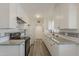 Updated kitchen with white cabinets, granite countertops, and stainless steel appliances at 3202 W Glenrosa Ave, Phoenix, AZ 85017