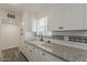 Beautifully updated kitchen with granite counters and white cabinets and subway tile backsplash at 3202 W Glenrosa Ave, Phoenix, AZ 85017